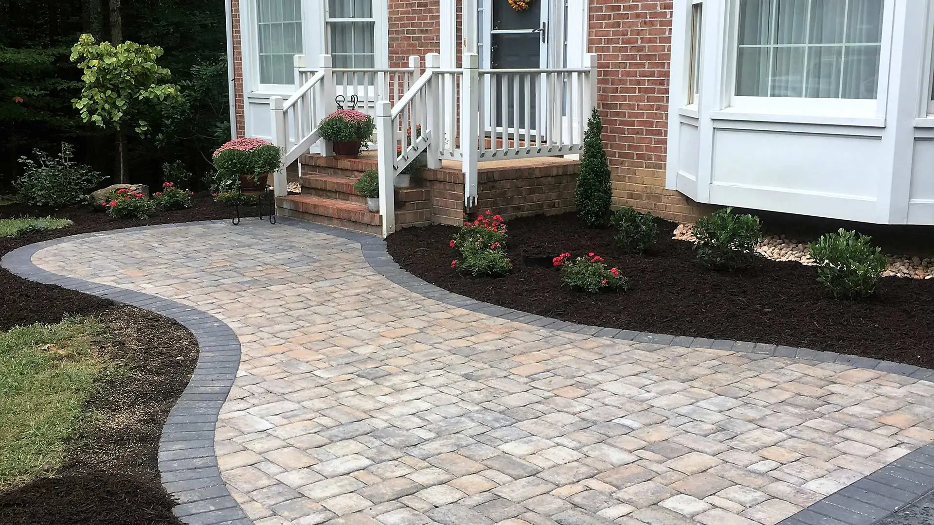 Paver patio surrounded by mulched landscape beds