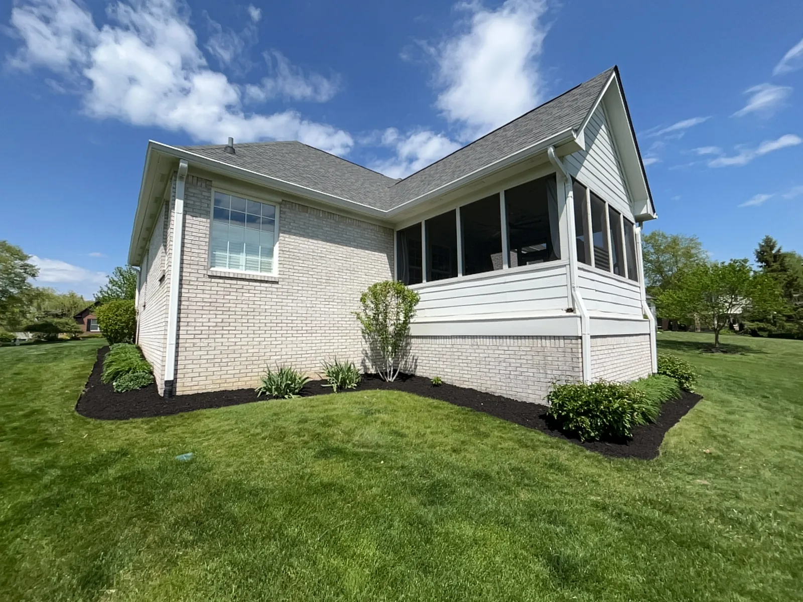 Carmel landscape bed after Sprout mulch refresh with fresh black mulch and clean edge