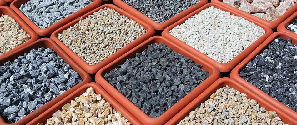Different varieties of mulch and rock in buckets