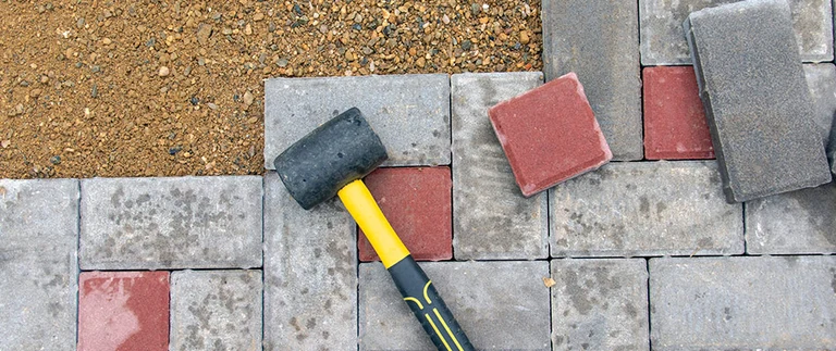 Individual pavers being replaced during repair