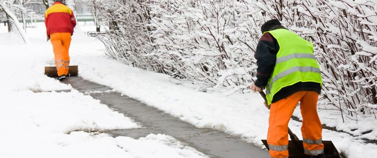 Crew shoveling walkway after snowfall