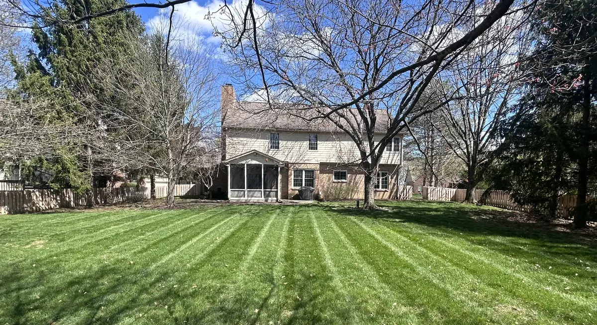 Backyard with mowing stripes and mature trees in Noblesville Indiana